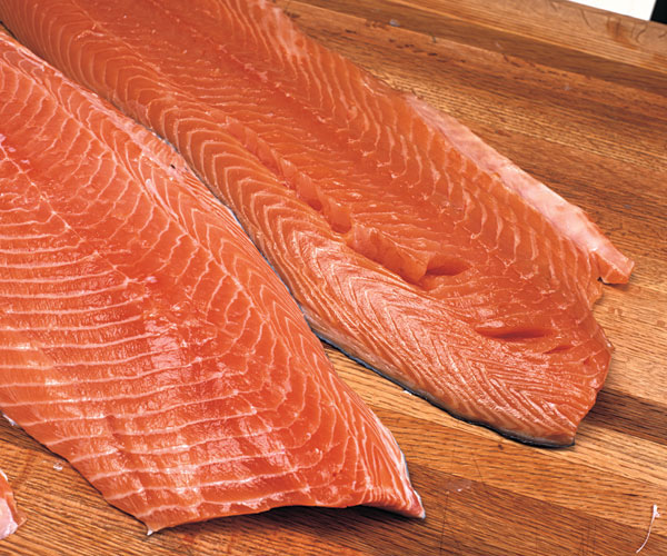 The fillets dry in the fridge while you sleep. A light glaze, called the pelicle, means the fish is sufficiently dried. It's hard to see, but the fillet in front has been dried.