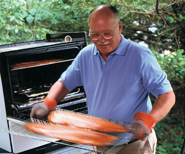 If you're going to spend ten hours smoking fish, you might as well smoke a lot of it. Ed's customized oven holds up to six whole salmon fillets-which makes his friends very happy.